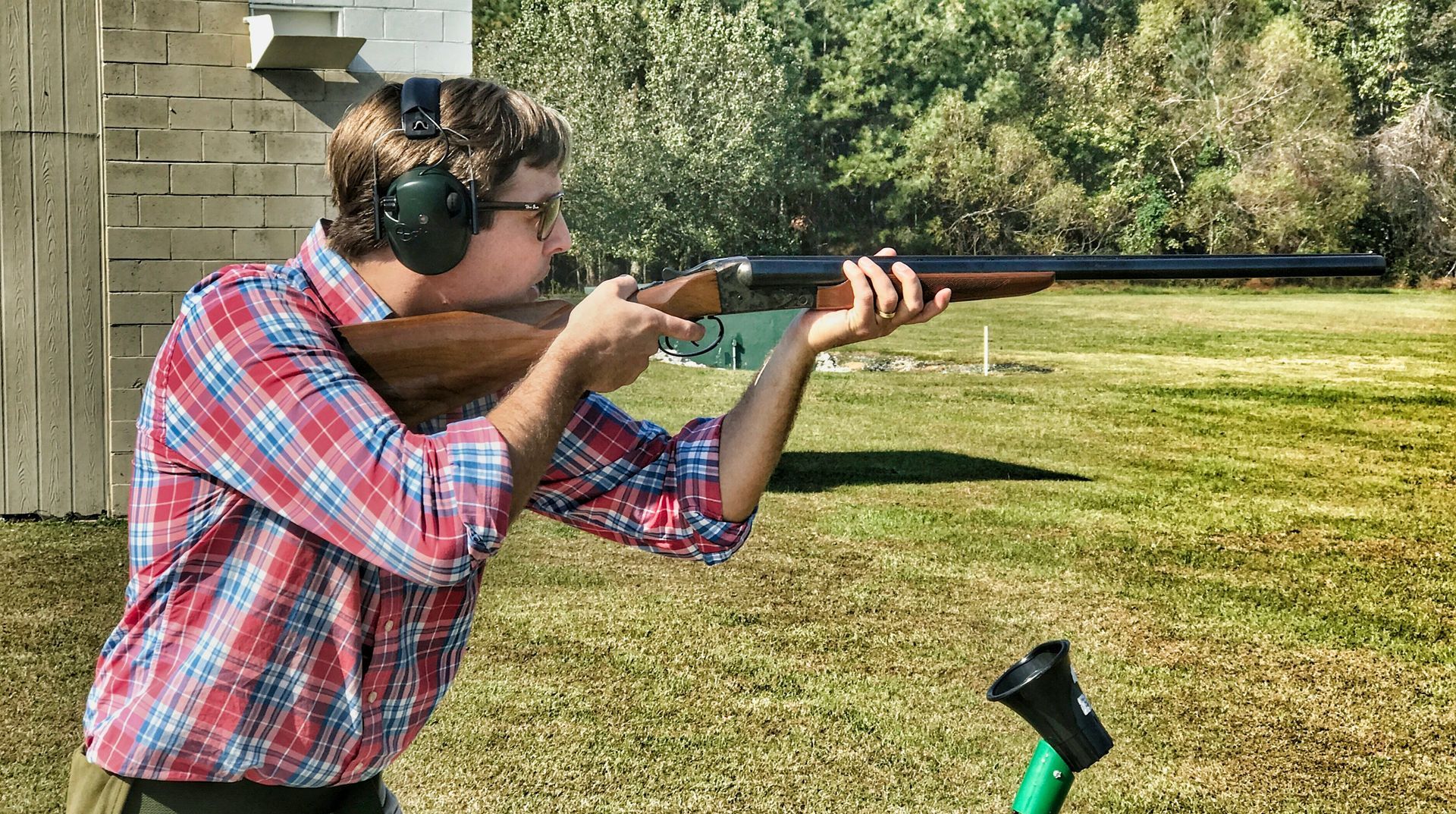 man shooting shotgun