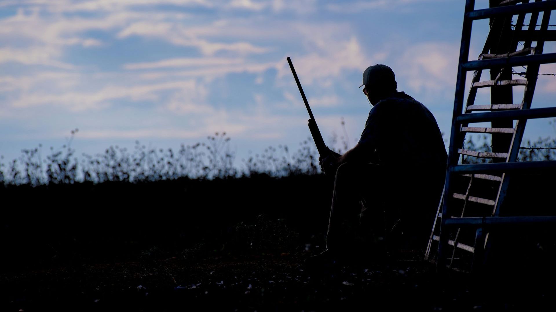 man holding a shotgun