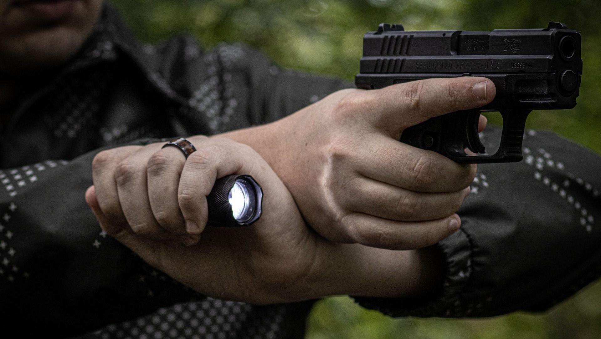 man shooting a handgun