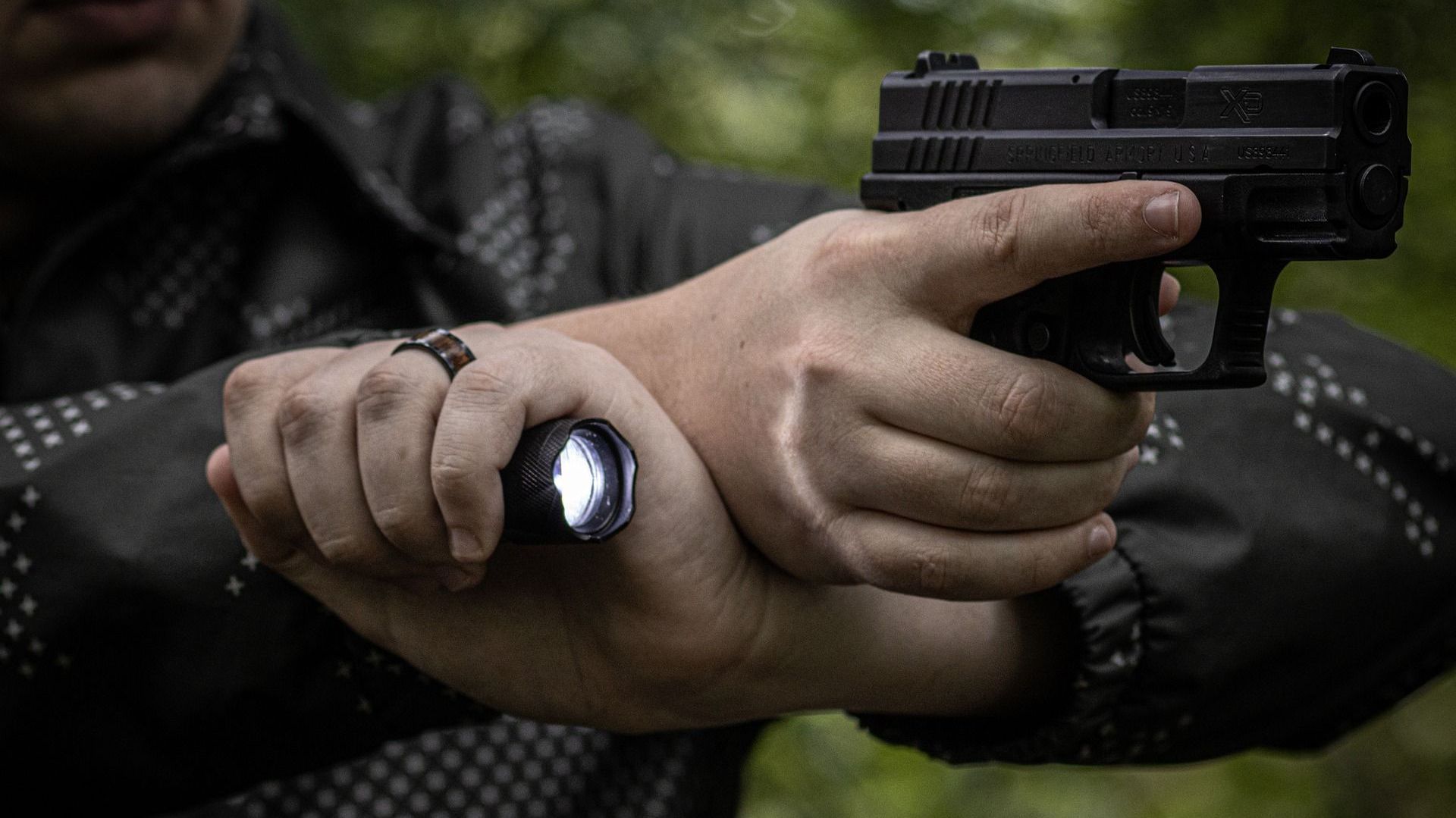 man shooting a handgun