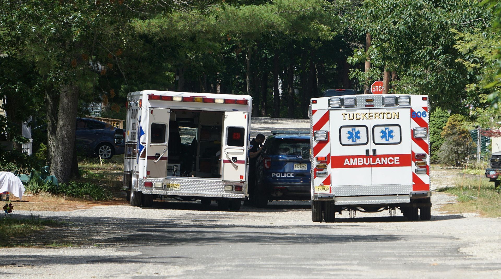 Two ambulances are parked on the side of the road.