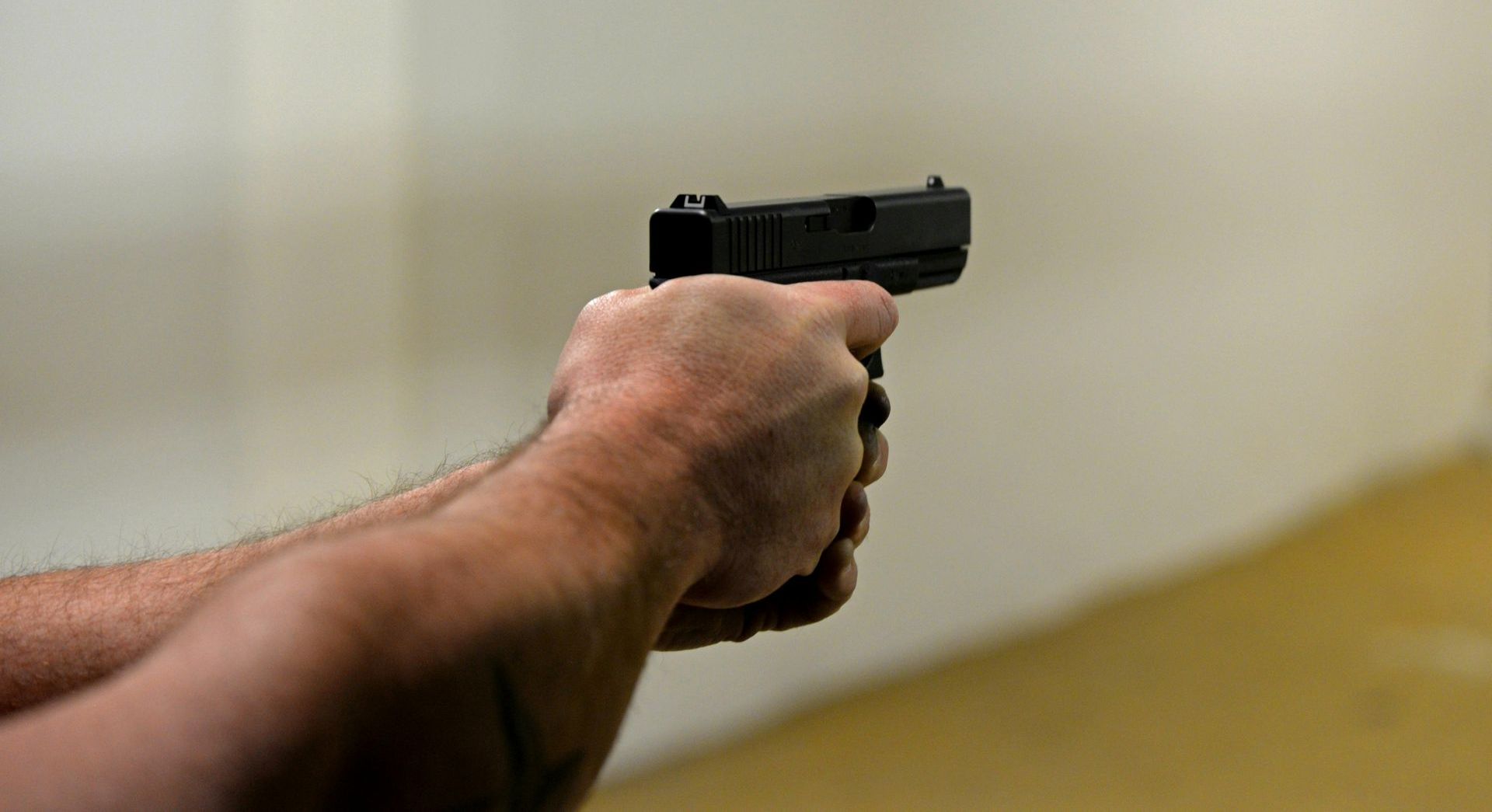 man shooting a pistol