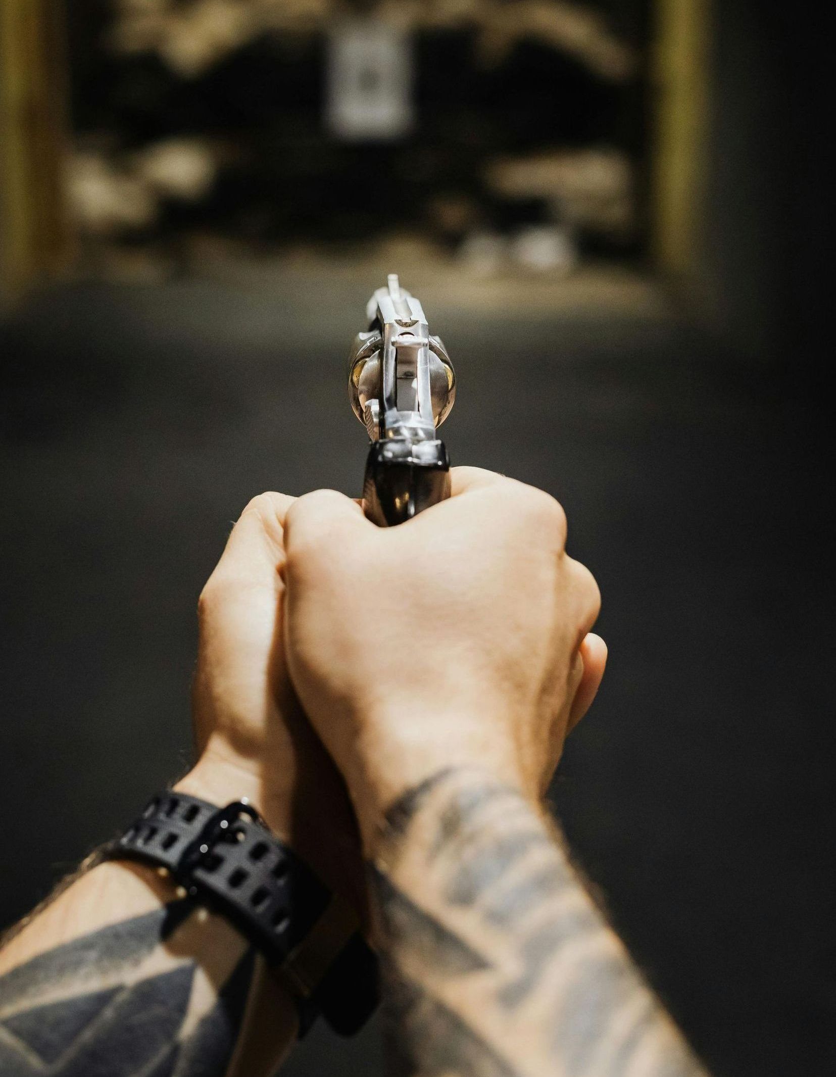 man shooting a handgun