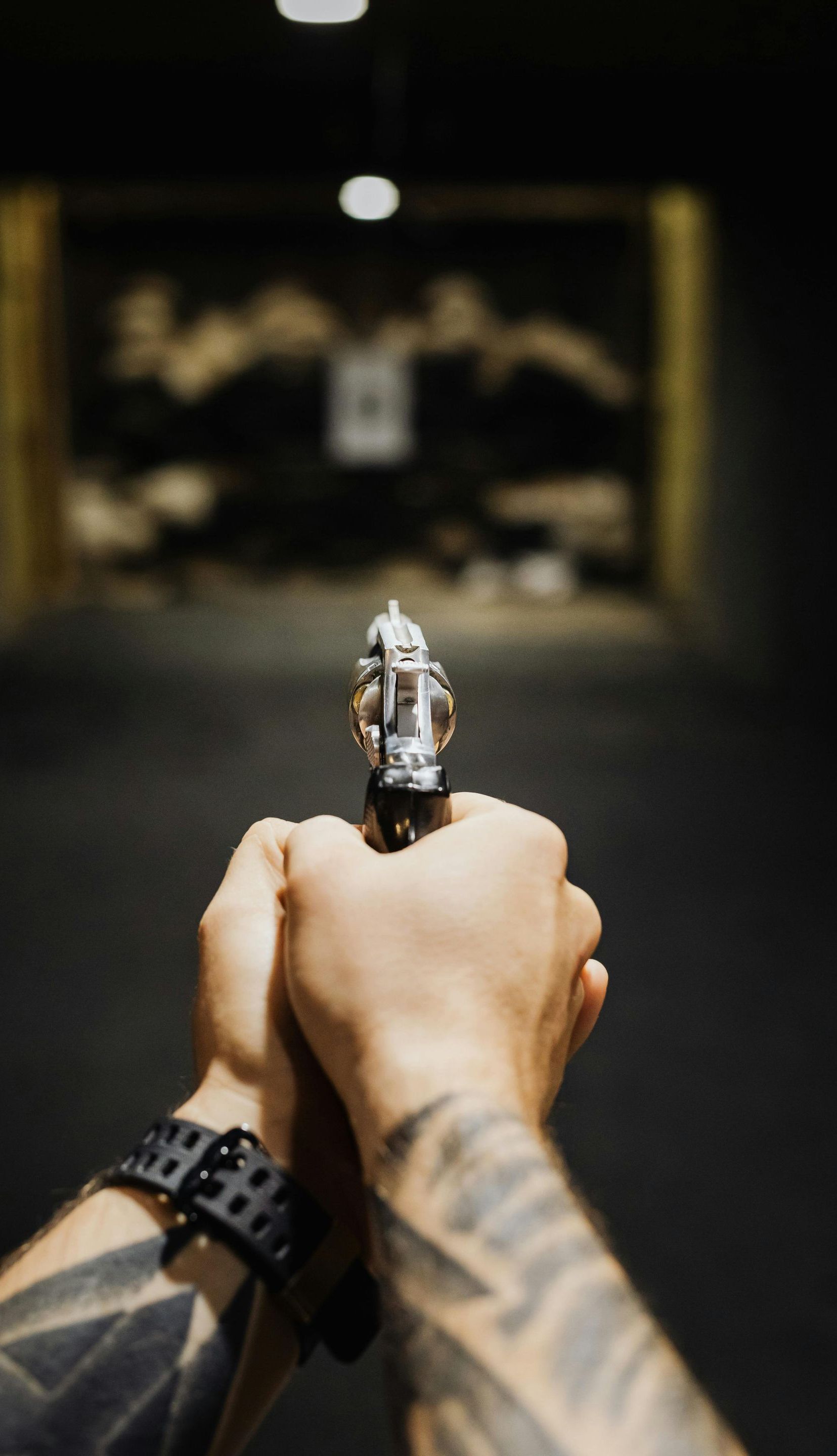 man shooting a handgun