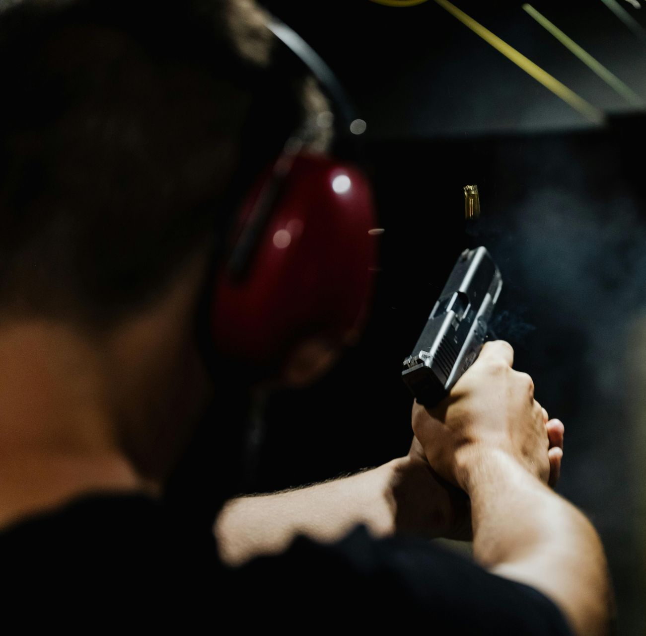 man shooting at a target at a shooting range