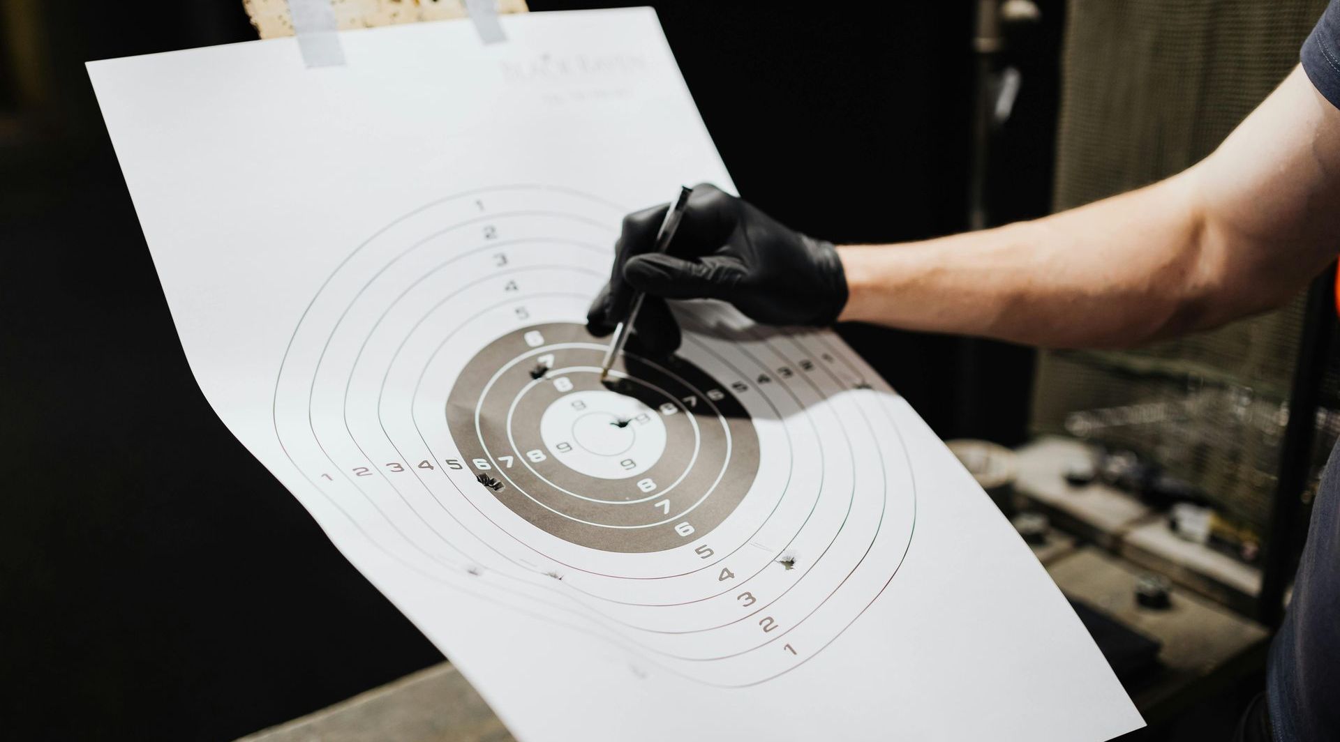 man examining a target that has been shot at