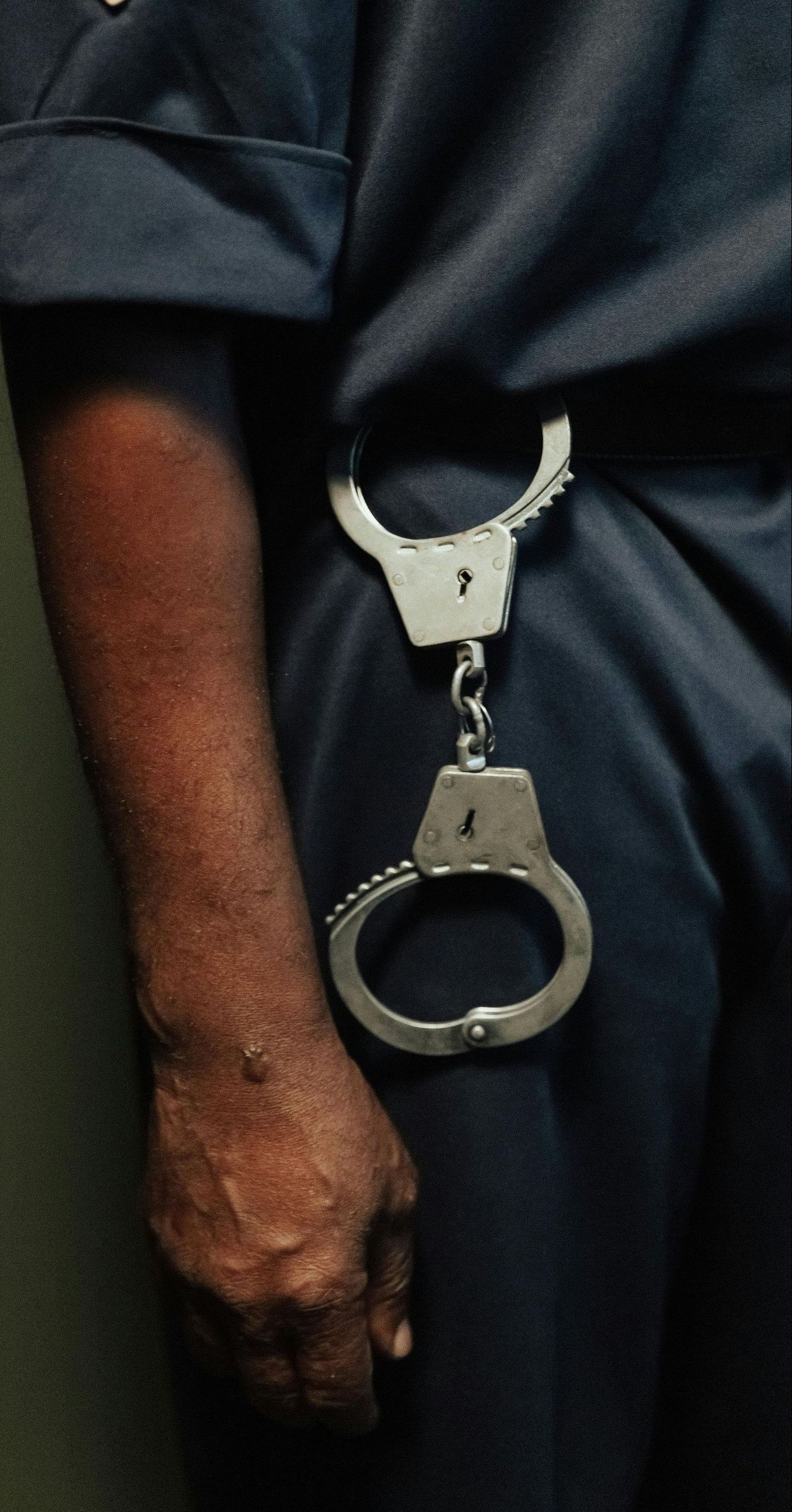 A man wearing a pair of handcuffs around his waist