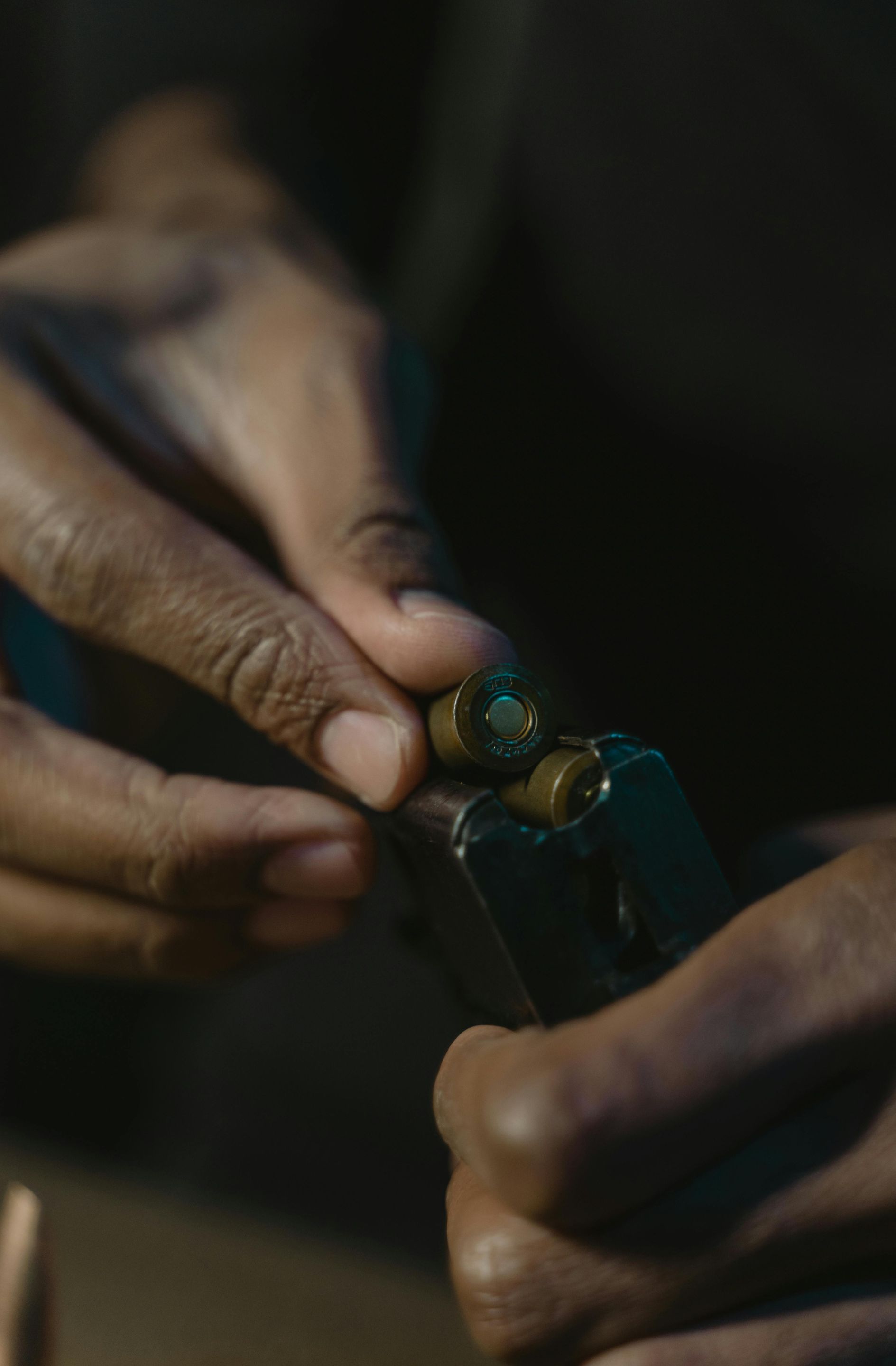 A close up of a person holding a handgun in their hands.