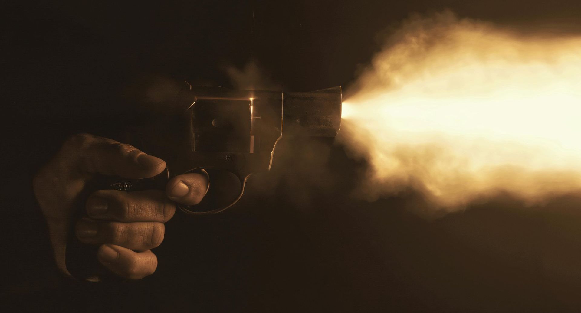 person firing a handgun