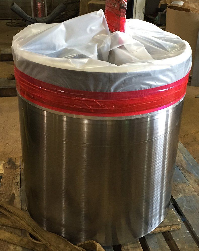 a large metal cylinder is wrapped in plastic and red tape