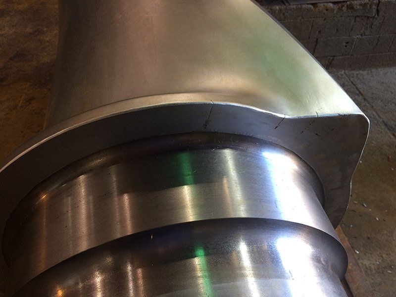 a close up of a metal object with a green light shining on it