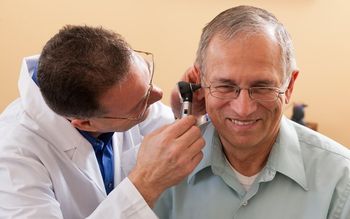 Elderly man getting his ears checked