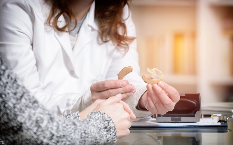 Woman educating person about hearing loss