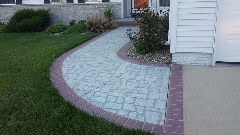Front yard with patterned stone walkway — Cedar Rapids, IA — Earthworks Concrete