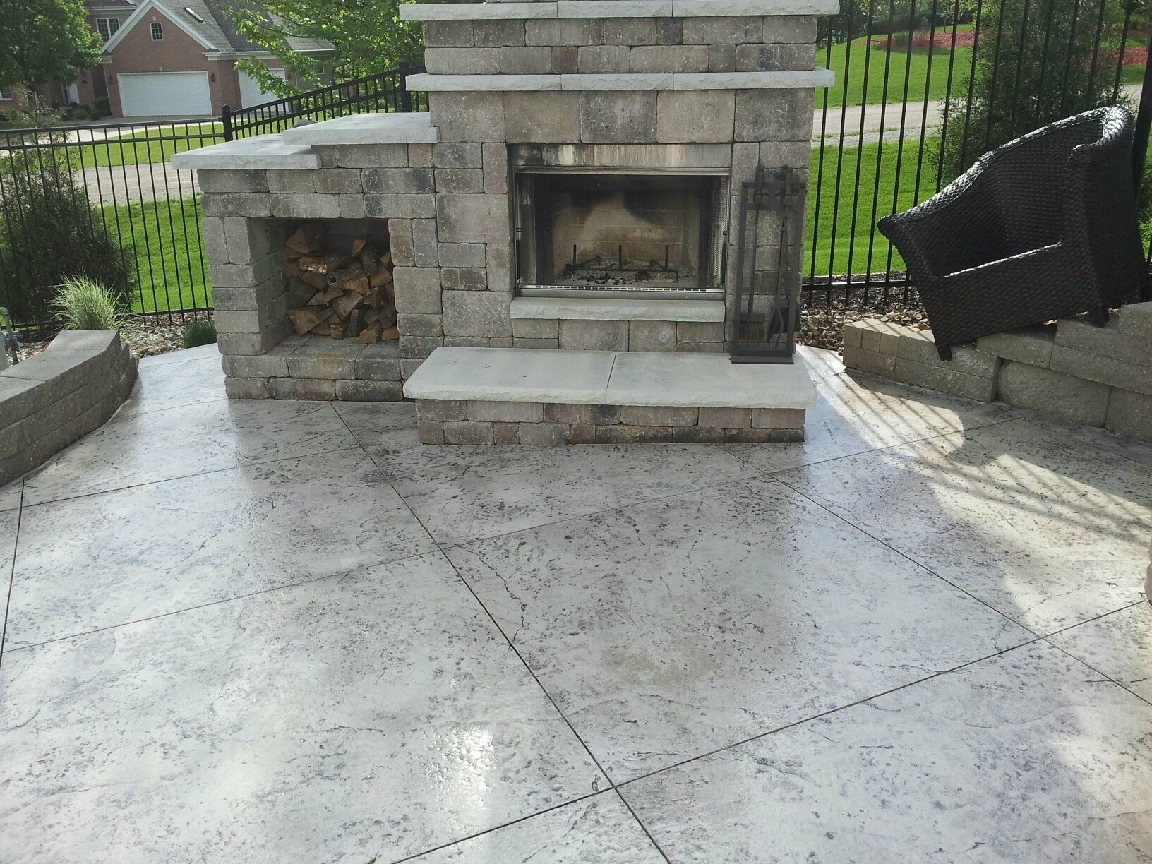 Patio with large fireplace and seat next to it — Cedar Rapids, IA — Earthworks Concrete