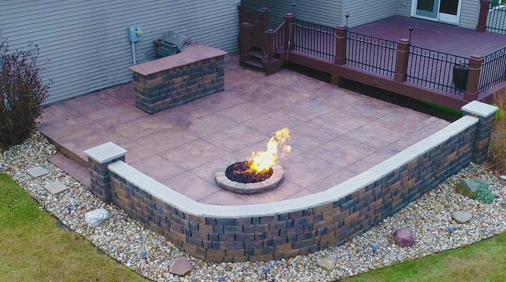 Patio with circular fireplace — Cedar Rapids, IA — Earthworks Concrete