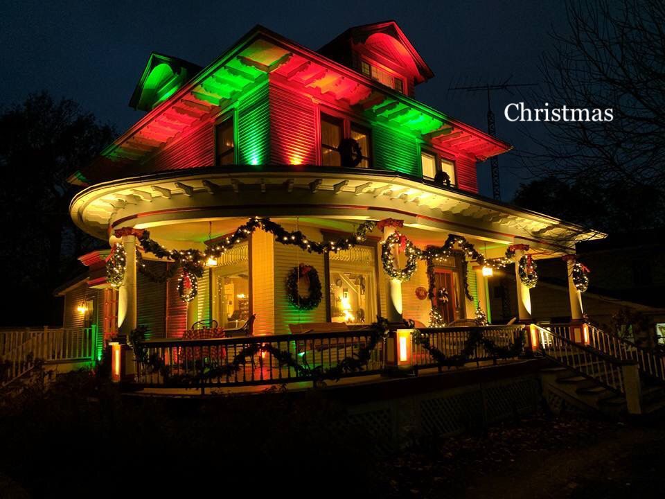 A house is decorated for christmas with red and green lights