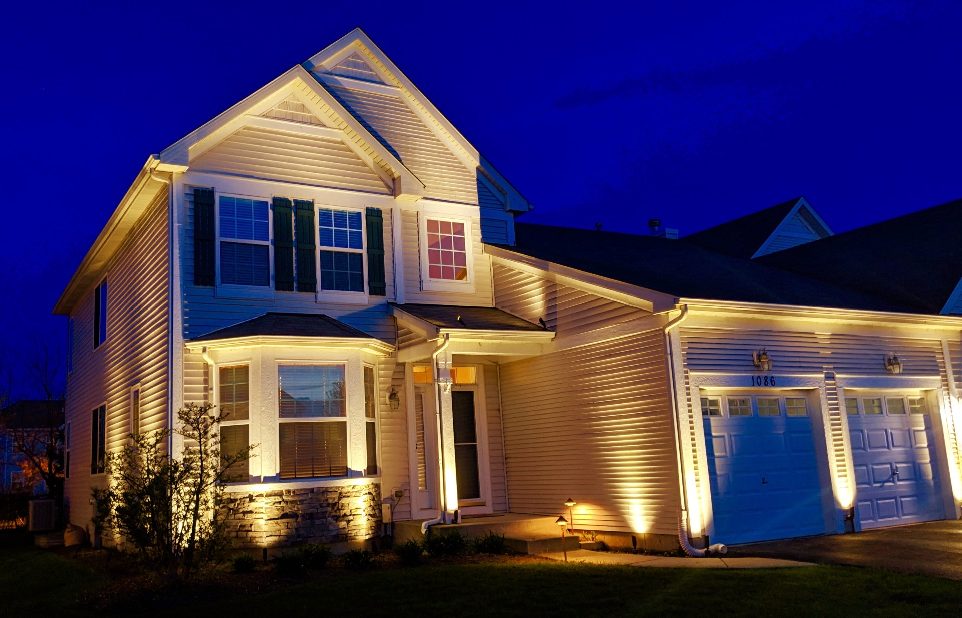 The front of a house is lit up at night
