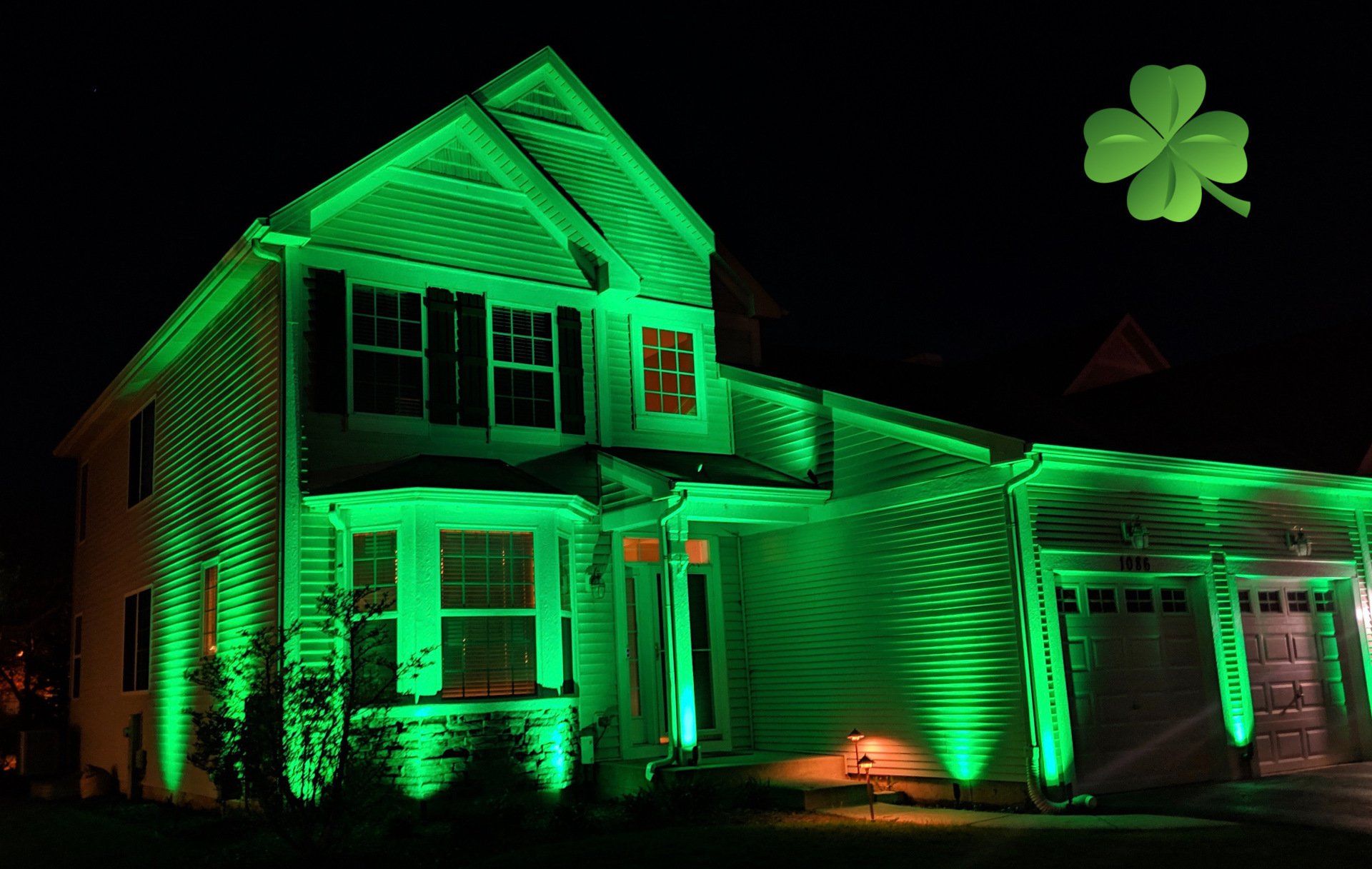 A house is lit up with green lights for st. patrick 's day.