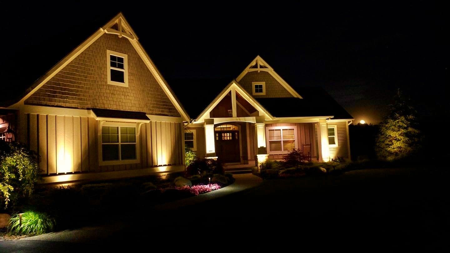 A house is lit up at night with a lot of lights on it.