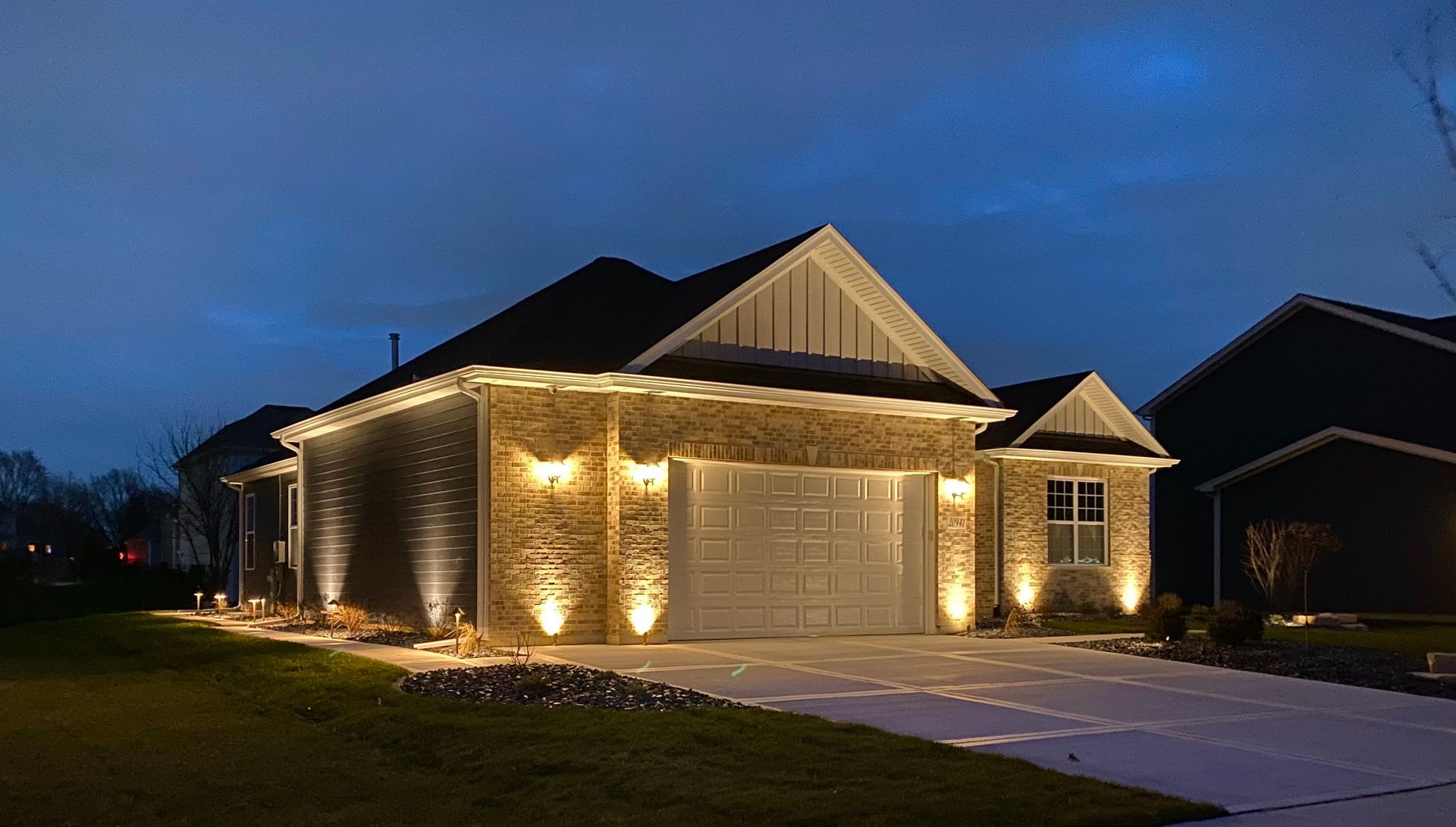 A house is lit up at night with christmas lights.
