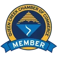 Queen Creek Chamber of Commerce Member logo featuring a blue mountain and river graphic inside a gold and blue circle.