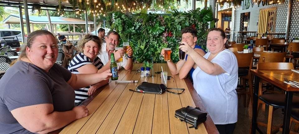 A Group of People Cheers With Drinks at a Bar — Capricorn Tavern in Taranganba, QLD