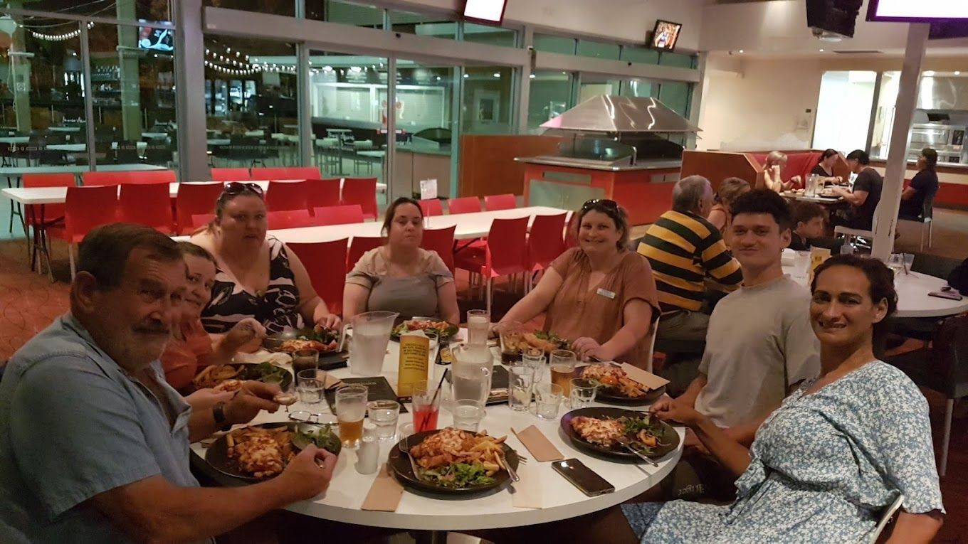 People Eating at a Round Table in a Restaurant — Capricorn Tavern in Taranganba, QLD