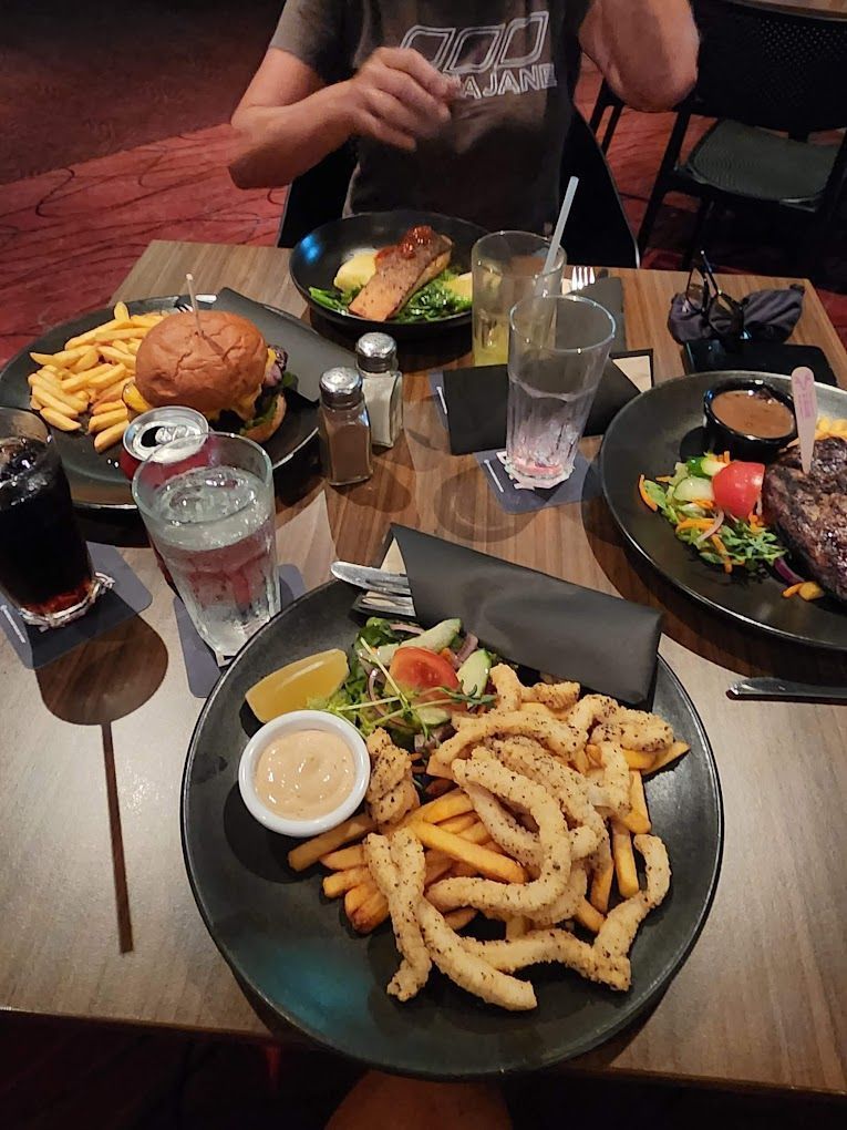 Table With Various Dishes — Capricorn Tavern in Taranganba, QLD