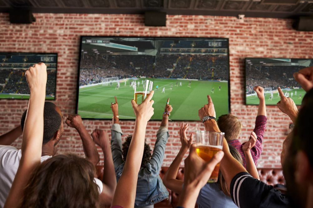 People Cheering in a Bar, Watching a Sports Game on Large Tvs — Capricorn Tavern in Taranganba, QLD