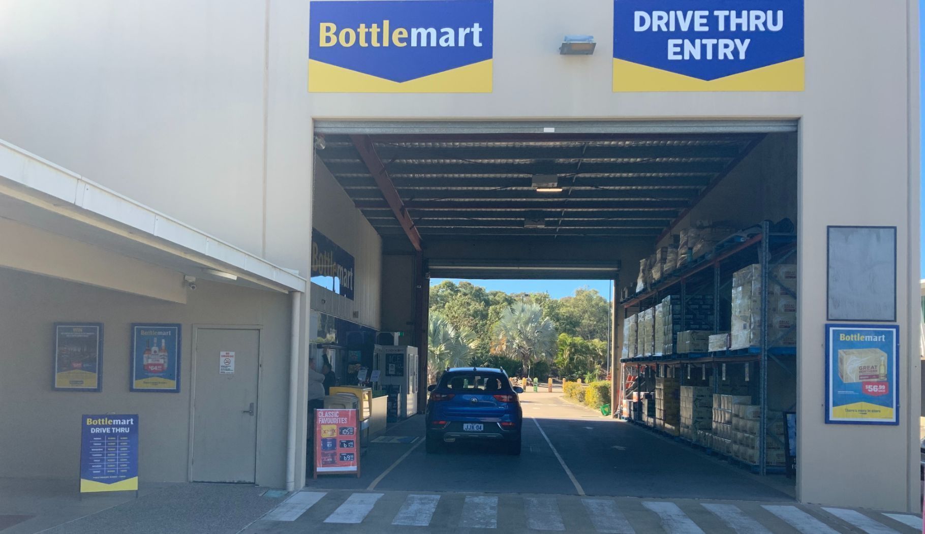 Bottle Shop Interior With Refrigerated Drink Displays and Checkout Counter — Capricorn Tavern in Taranganba, QLD