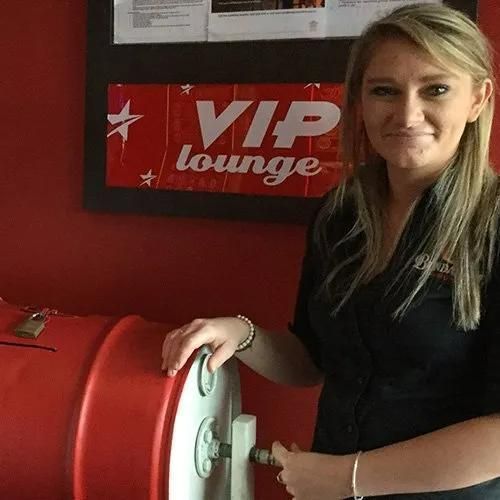 Woman in Black Shirt by a Red Barrel in a VIP Lounge — Capricorn Tavern in Taranganba, QLD