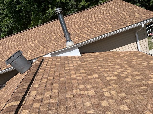 A brown roof with a chimney on top of it