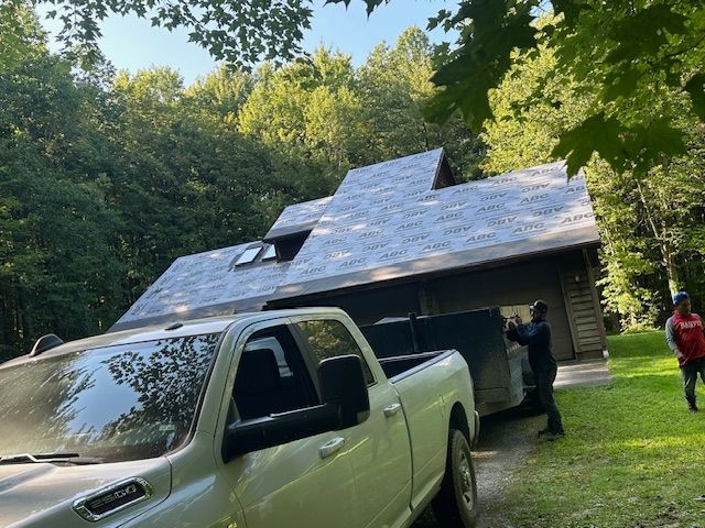 A white truck is parked in front of a house.