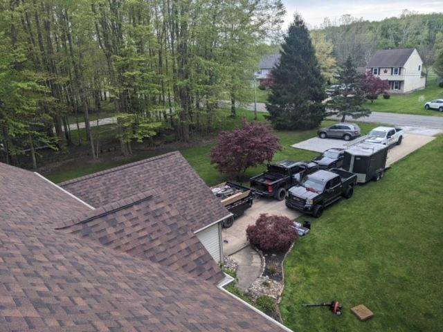 An aerial view of a house with a lot of cars parked in front of it.