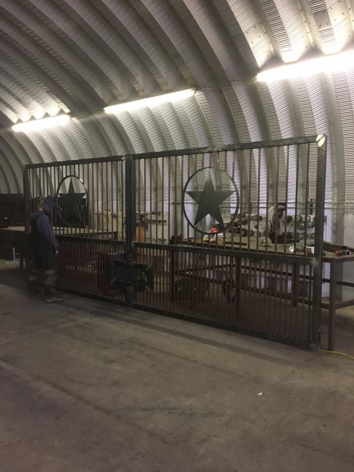 A large metal fence with a star on it is in a building.