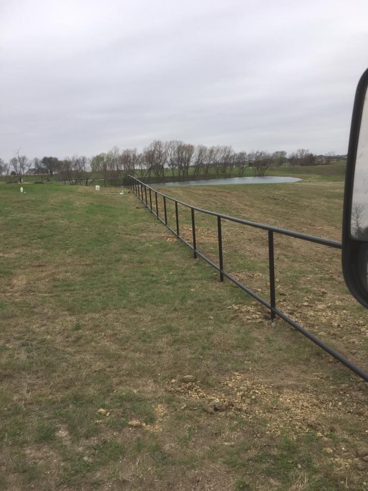 There is a fence in the middle of a field.