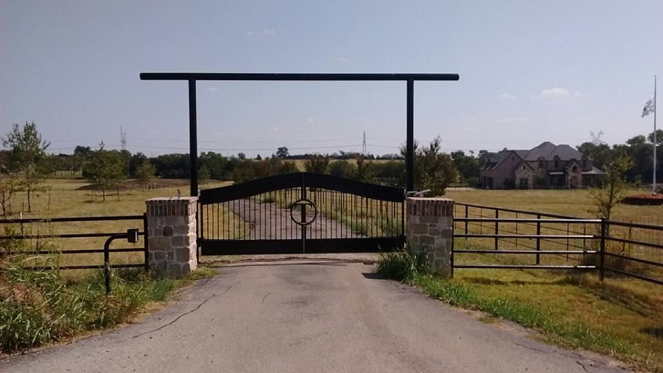 A black gate on the side of a road