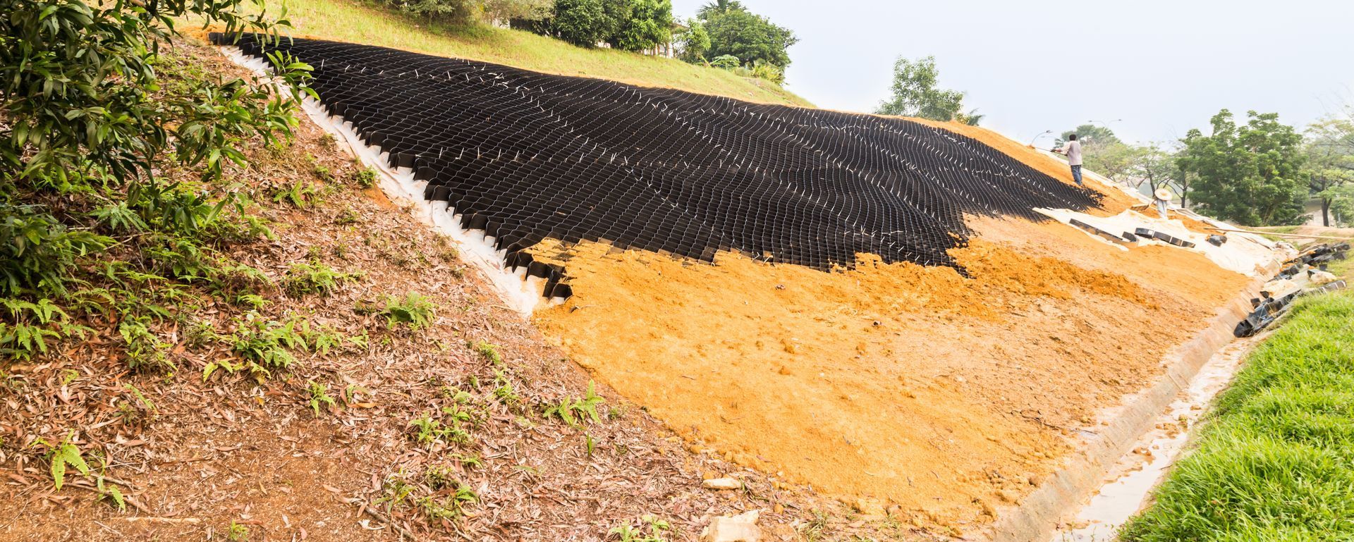 A large pile of dirt is sitting on top of a hill.