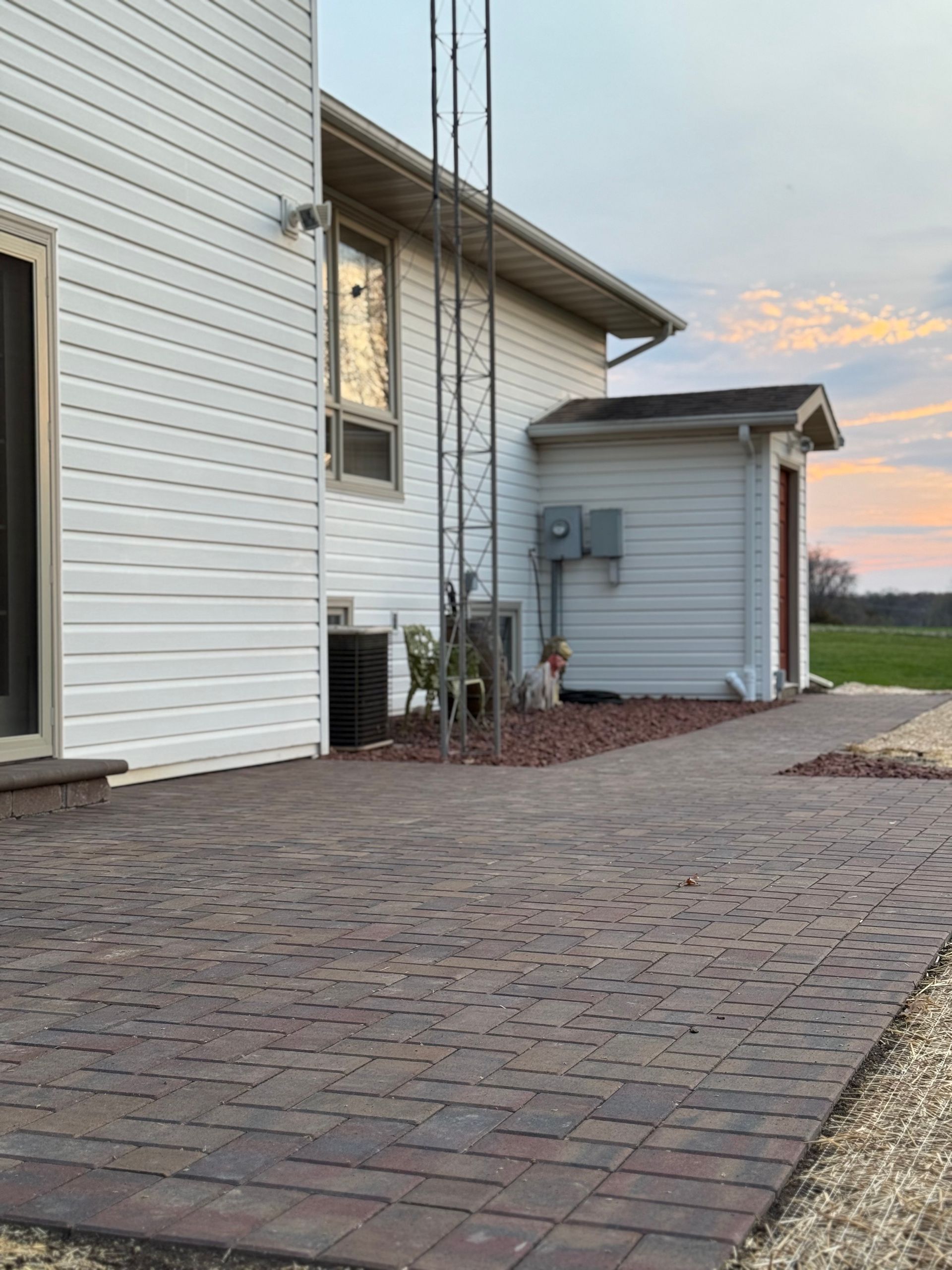 A row of bricks are sitting on top of each other on a sidewalk.
