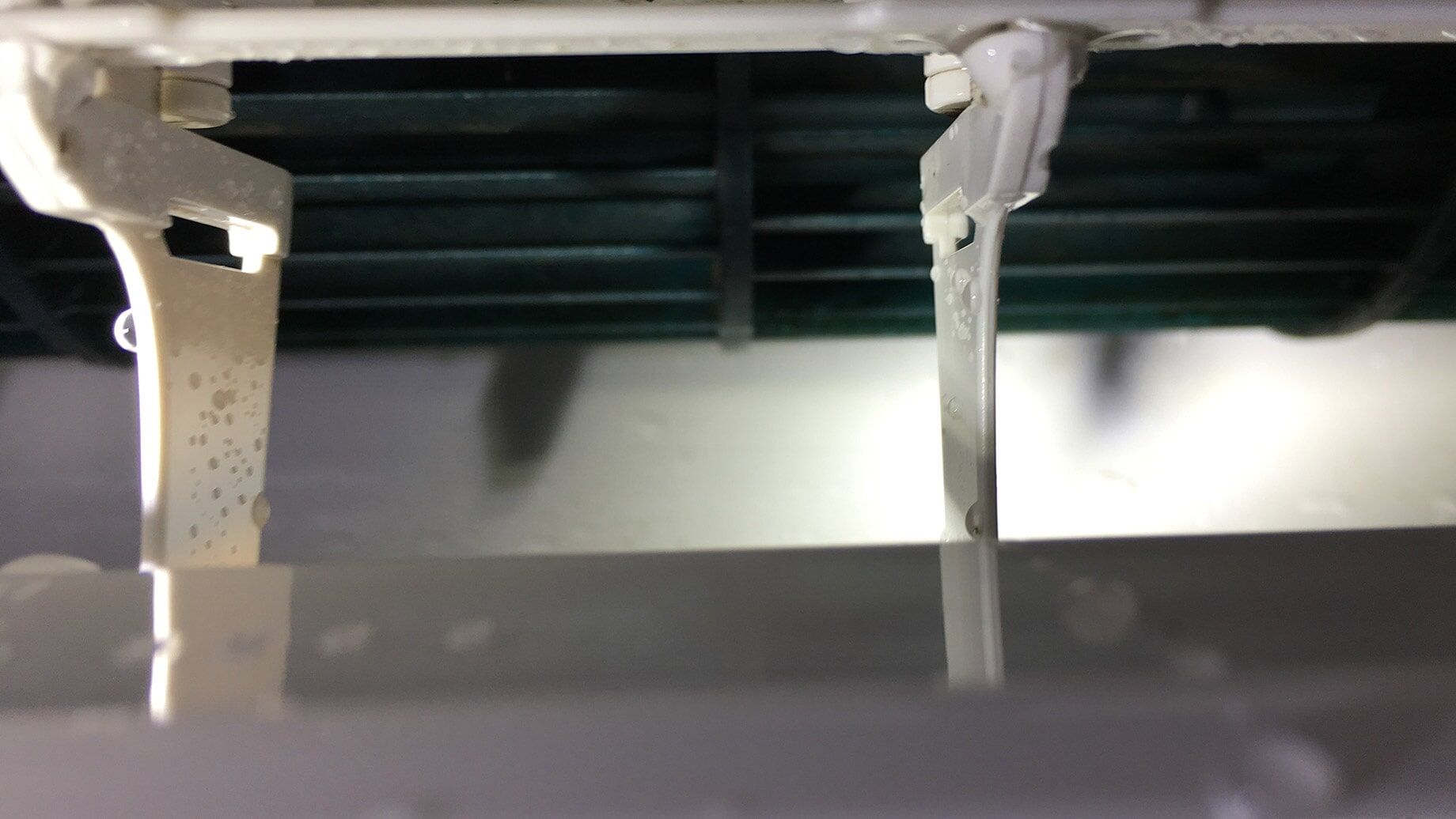 White air conditioning unit interior, showing fins and water droplets — EcoAir Conditioning in Coconut Grove, NT