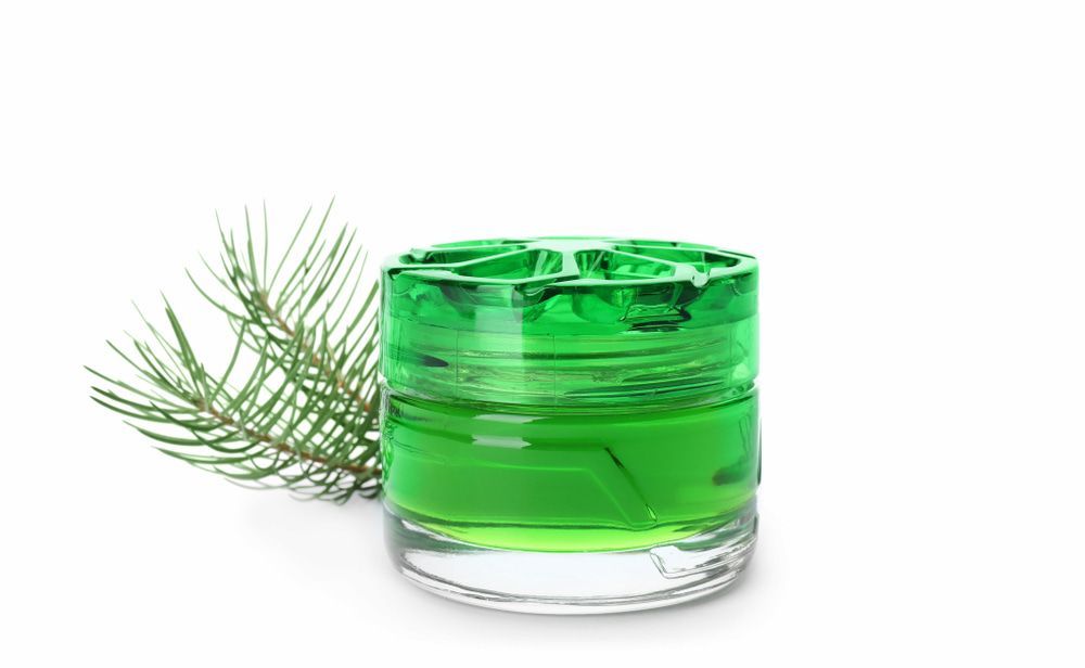 Glass Jar Filled With Green Liquid, Next to a Sprig of Pine Needles, on White — EcoAir Conditioning in Coconut Grove, NT
