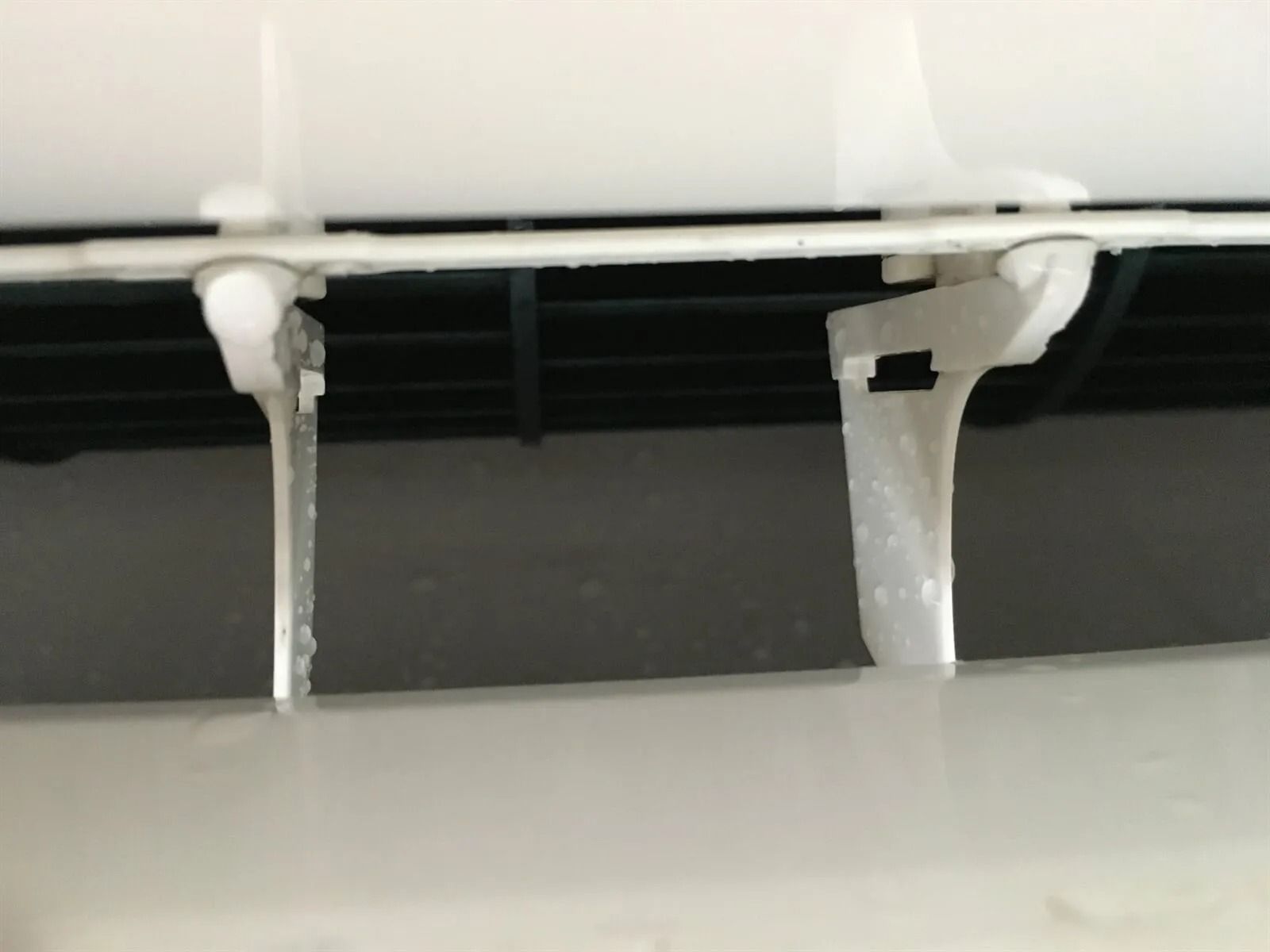 Close-up view of an air conditioner vent with ice buildup on the louvers — EcoAir Conditioning in Coconut Grove, NT