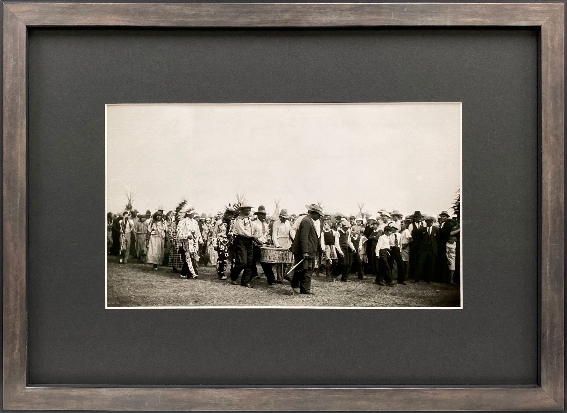 A black and white photo of a group of people in a field