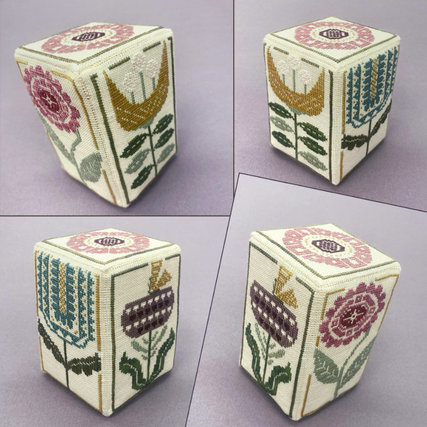 A cube with flowers and leaves embroidered on it