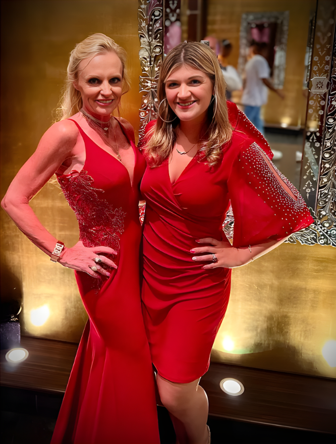 A smiling doctor in a lab coat with a stethoscope around his neck.