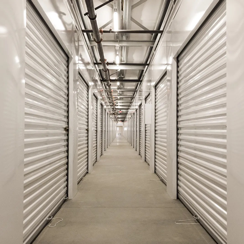 long, indoor hallway of storage unit doors