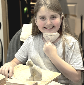 Soapstone Girl Carving a Cat