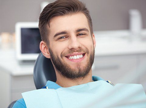 Periodontics Dentists — Happy Patient on Dental Chair in Birmingham, AL