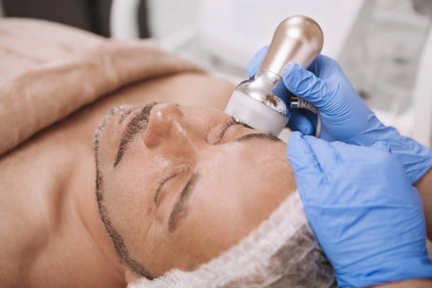 A man is getting a facial treatment at a beauty salon.
